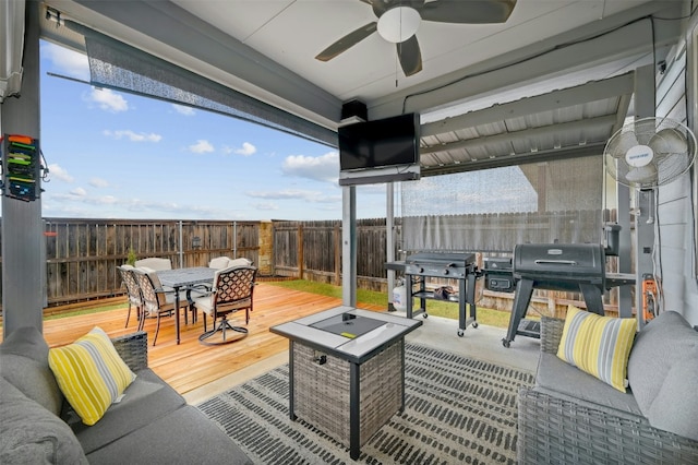 view of patio featuring a wooden deck, ceiling fan, and outdoor lounge area