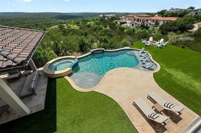 view of swimming pool with an in ground hot tub, a patio area, and a lawn