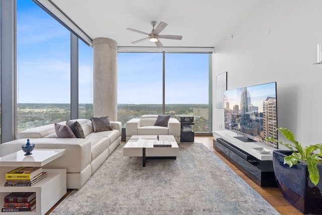 living room with hardwood / wood-style floors, floor to ceiling windows, and ceiling fan