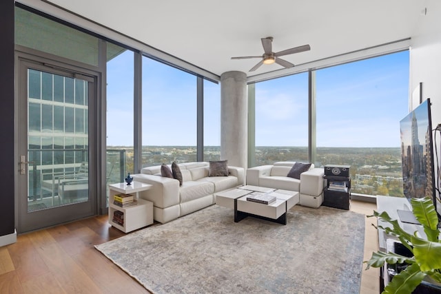 sunroom / solarium featuring a wealth of natural light and ceiling fan