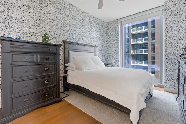 bedroom with hardwood / wood-style floors and ceiling fan