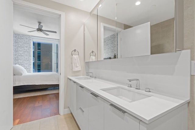 bathroom featuring ceiling fan, wood-type flooring, and vanity