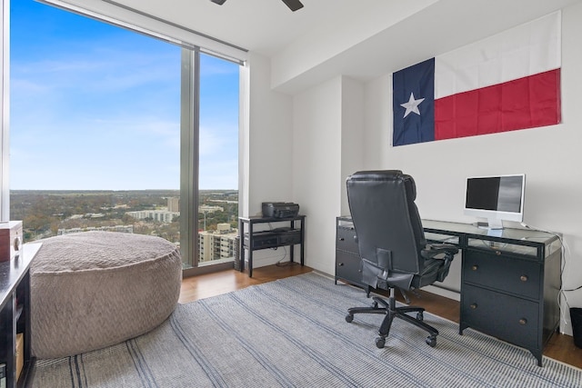 home office with hardwood / wood-style floors and ceiling fan