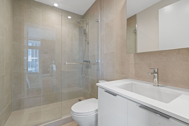 bathroom featuring vanity, an enclosed shower, tile walls, and toilet