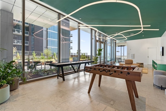 recreation room with a notable chandelier and floor to ceiling windows