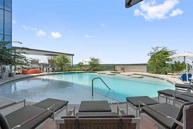 view of swimming pool with a patio area and a jacuzzi