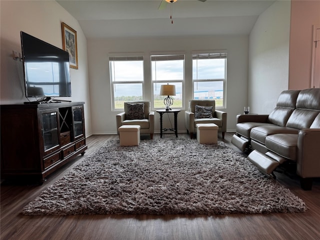 living room with lofted ceiling, wood finished floors, and baseboards