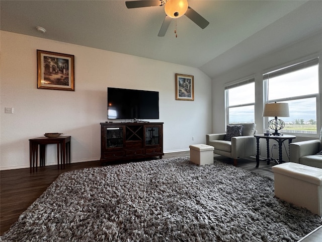 living room with ceiling fan, baseboards, vaulted ceiling, and wood finished floors