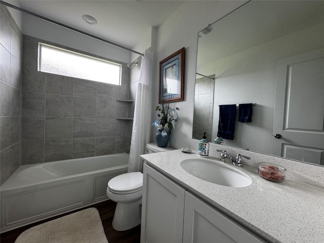 full bathroom featuring wood finished floors, vanity, toilet, and shower / bath combo with shower curtain