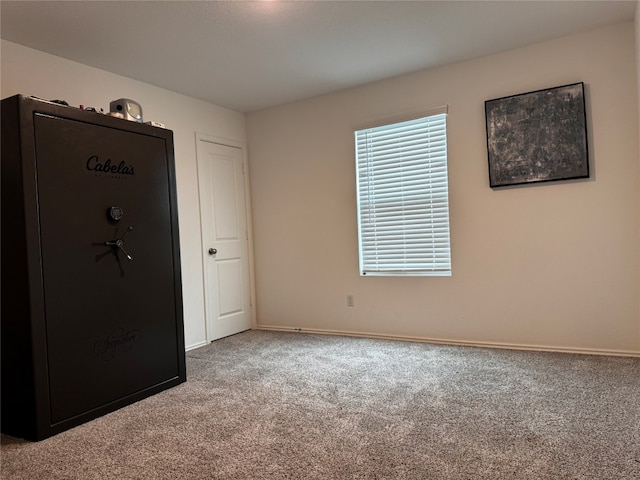 unfurnished bedroom featuring carpet and baseboards