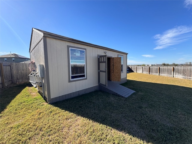 exterior space with an outdoor structure and a fenced backyard