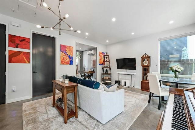 living room featuring concrete flooring, a chandelier, and a wall mounted AC