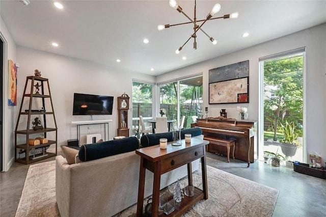 living room with concrete flooring and an inviting chandelier