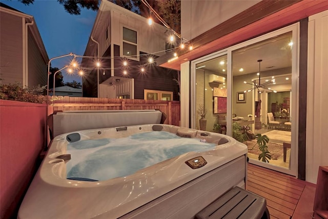 exterior space with a wall unit AC, a wooden deck, and a hot tub