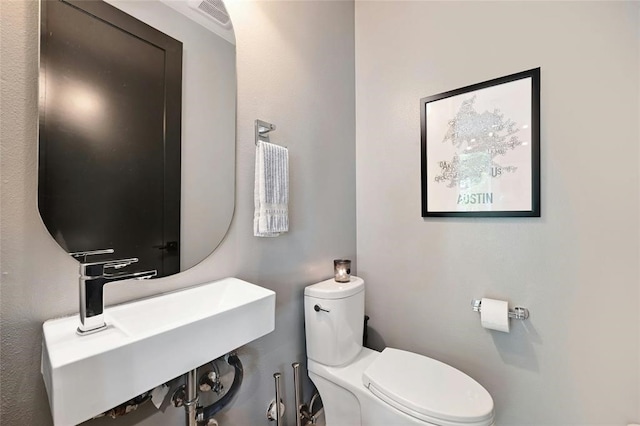 bathroom featuring sink and toilet