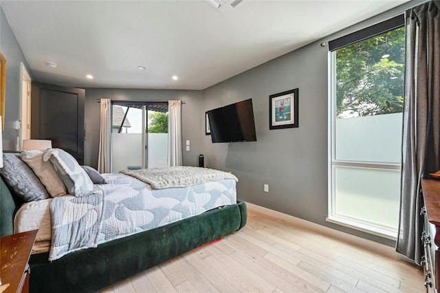 bedroom with access to exterior and light wood-type flooring