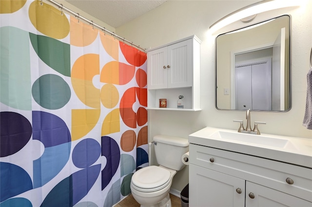 bathroom featuring walk in shower, vanity, a textured ceiling, and toilet