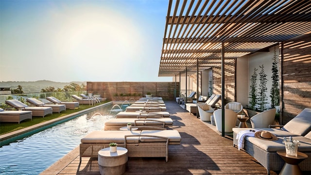 view of patio / terrace featuring a mountain view, pool water feature, and a fenced in pool