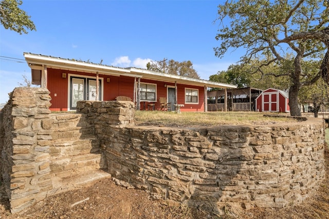 view of front of home with a shed