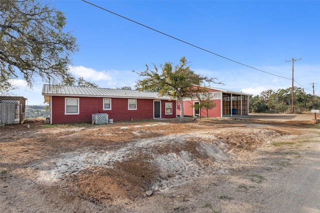 ranch-style home with metal roof