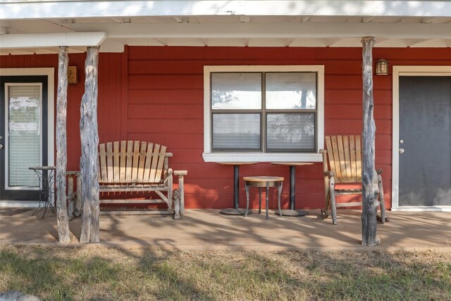 view of exterior entry featuring a porch