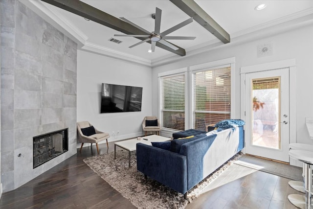 1503 Juliet St, Austin, TX 78704 - living area featuring ornamental molding, a ceiling fan, dark wood finished floors, beamed ceiling, and a fireplace