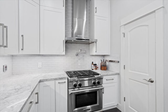 1503 Juliet St, Austin, TX 78704 - kitchen featuring gas range, wall chimney exhaust hood, white cabinets, and decorative backsplash