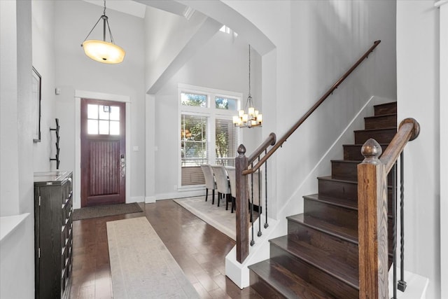 1503 Juliet St, Austin, TX 78704 - entrance foyer featuring a towering ceiling, a chandelier, stairway, dark wood finished floors, and arched walkways