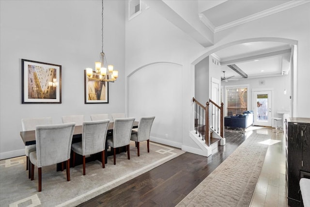 1503 Juliet St, Austin, TX 78704 - dining area with arched walkways, crown molding, wood finished floors, stairs, and beam ceiling
