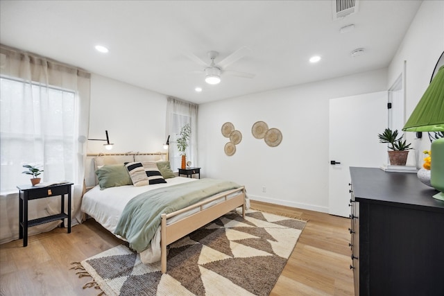 bedroom with light hardwood / wood-style flooring and ceiling fan