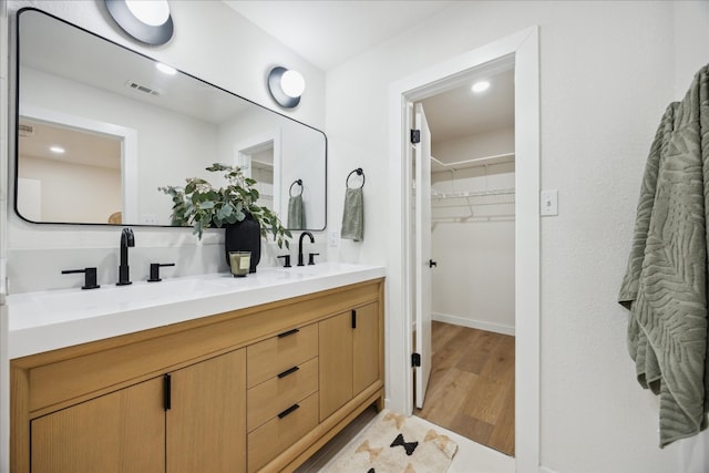 bathroom featuring vanity and hardwood / wood-style flooring