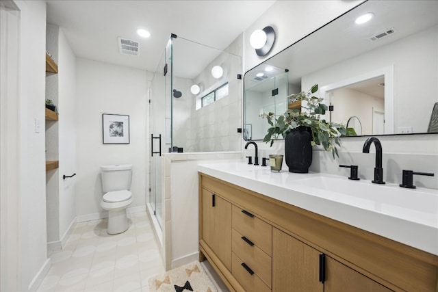 bathroom with an enclosed shower, vanity, toilet, and tile patterned floors