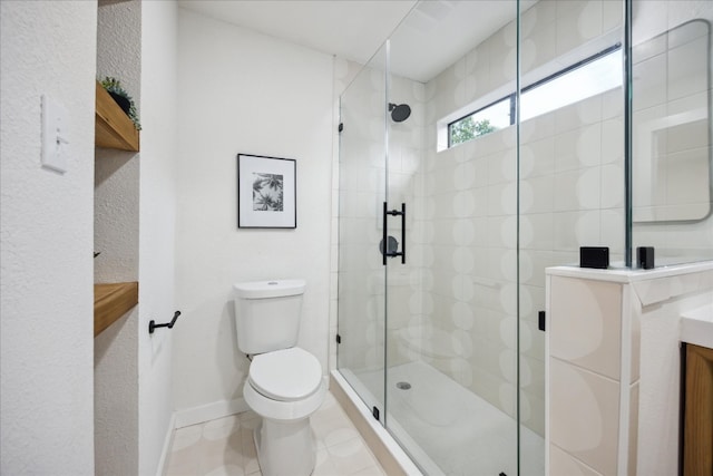 bathroom featuring tile patterned floors, vanity, toilet, and walk in shower