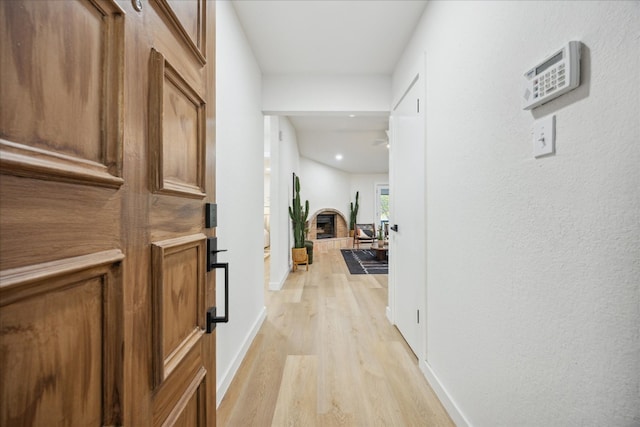 corridor with light hardwood / wood-style flooring