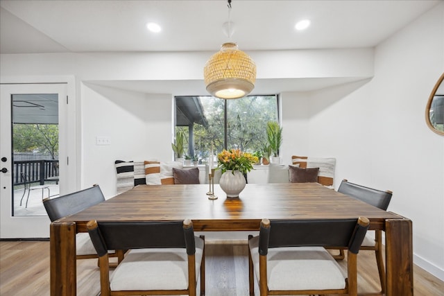 dining room with light wood-type flooring and a wealth of natural light