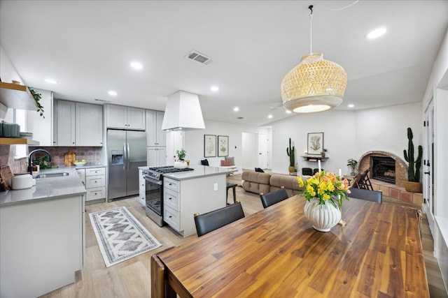 dining area featuring sink and light hardwood / wood-style flooring