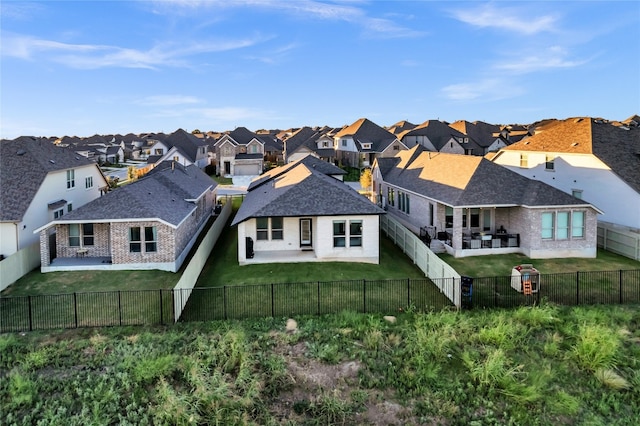 rear view of house with a yard and a patio