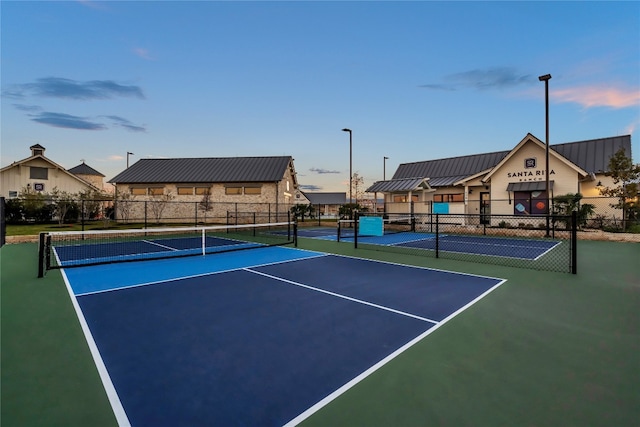 view of tennis court featuring basketball hoop