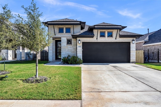 view of front of house with a front yard and a garage