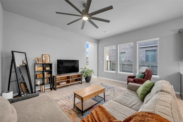 living room with ceiling fan and light hardwood / wood-style floors