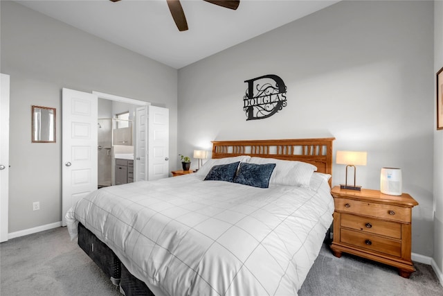 carpeted bedroom featuring ensuite bath and ceiling fan