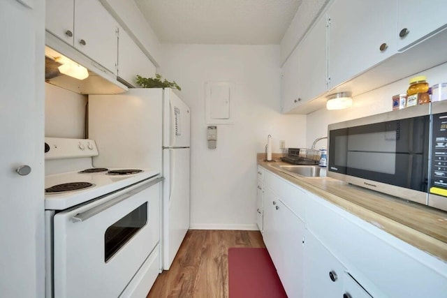 kitchen featuring white cabinetry, white range with electric cooktop, hardwood / wood-style flooring, and sink