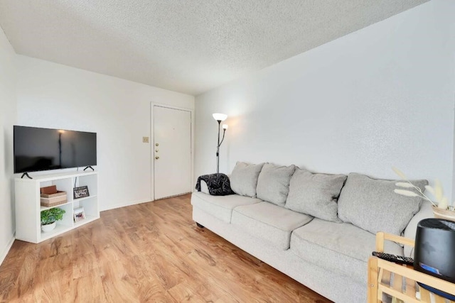 living room featuring hardwood / wood-style flooring and a textured ceiling