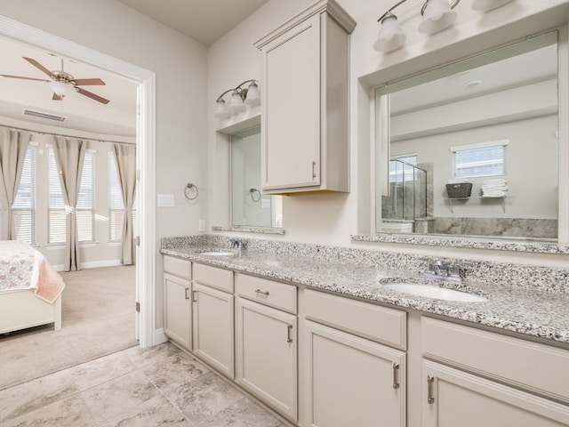 bathroom featuring ceiling fan, plenty of natural light, and vanity