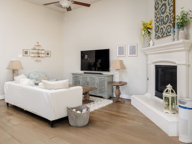 living room with ceiling fan and hardwood / wood-style floors