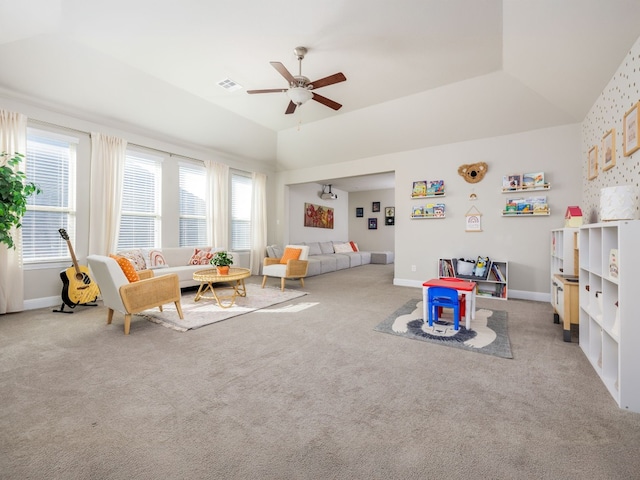 game room featuring ceiling fan, lofted ceiling, a raised ceiling, and carpet flooring