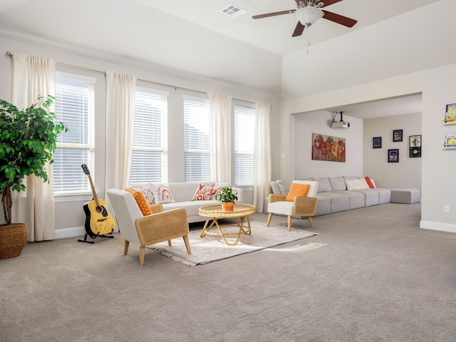 living room featuring ceiling fan, light colored carpet, and a wealth of natural light