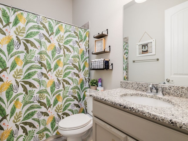 bathroom featuring toilet and vanity