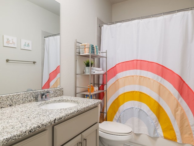 bathroom with toilet and vanity