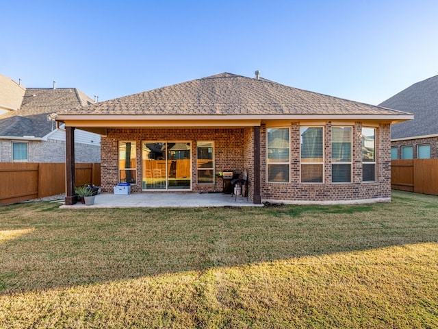 back of house with a lawn and a patio